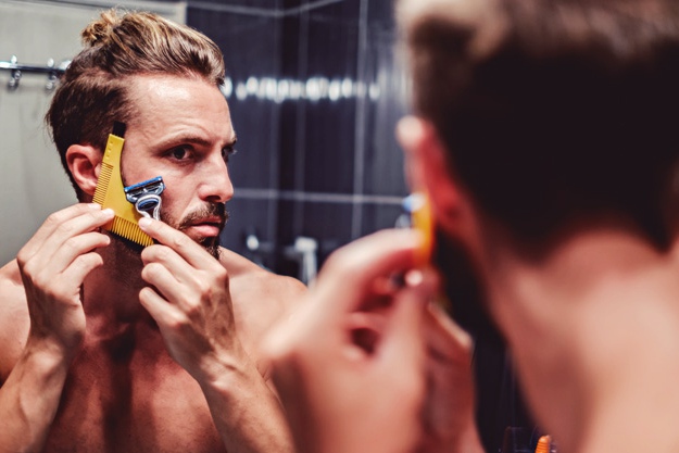 man trying to shave | Must Have Travel Items For Men To Survive Your Next Holiday Getaway
