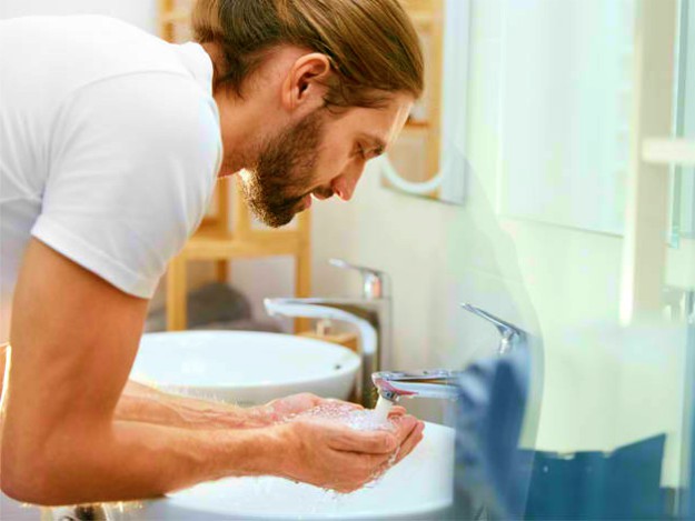 man washing his hands | Dry Skin On Face? Try These No-Bullsh*t Moisturizing Tips
