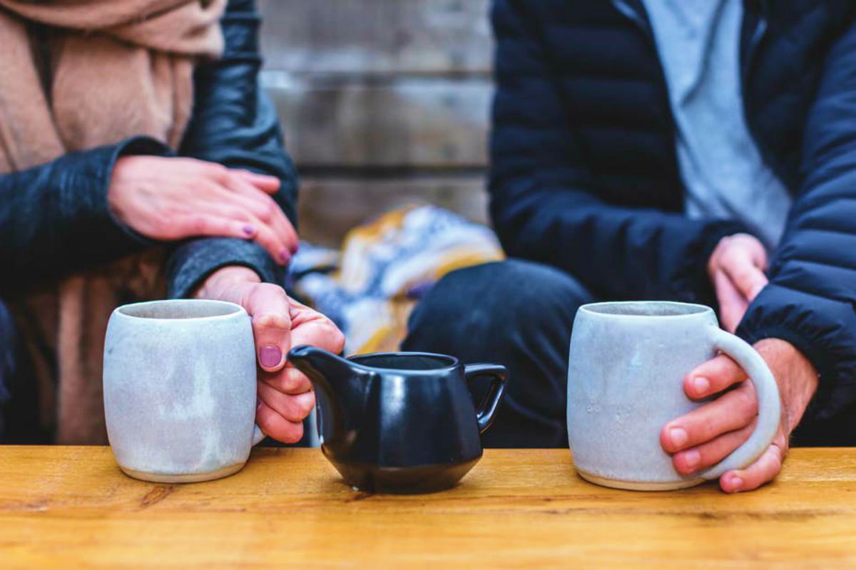 man and woman having a tea conversation | How to Impress A Girl Without Looking Like A Douche