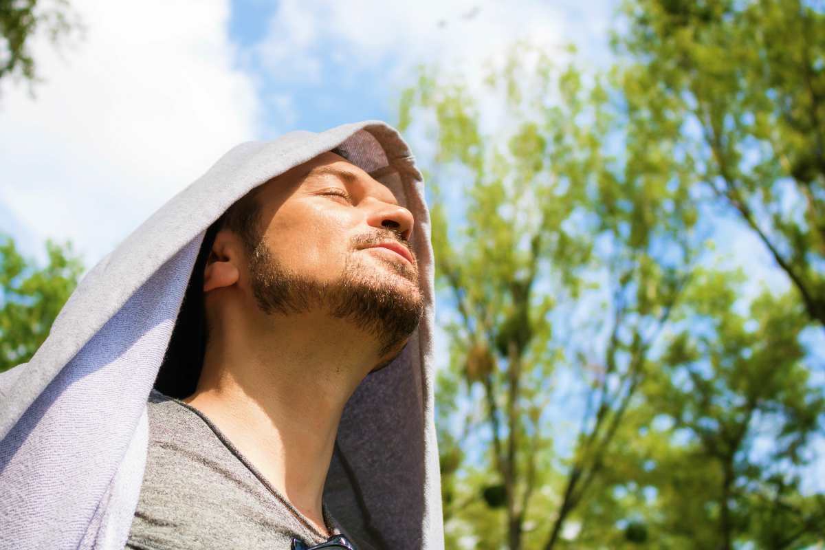 carefree man enjoying freedom and sunlight | Ways To Reconnect With Your Manliness This New Year | how to be a better man