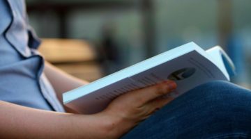 Feature | man reading a book outside | Must-Read Books Every Man Should Read | must read books of the 21st century