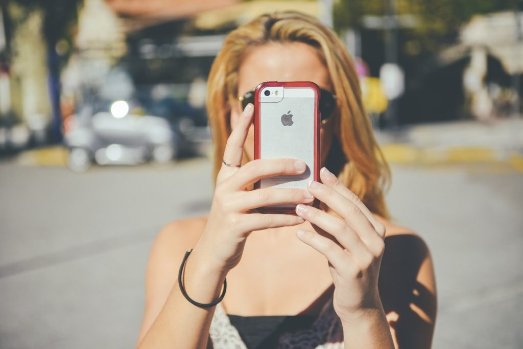woman taking a selfie with an iphone